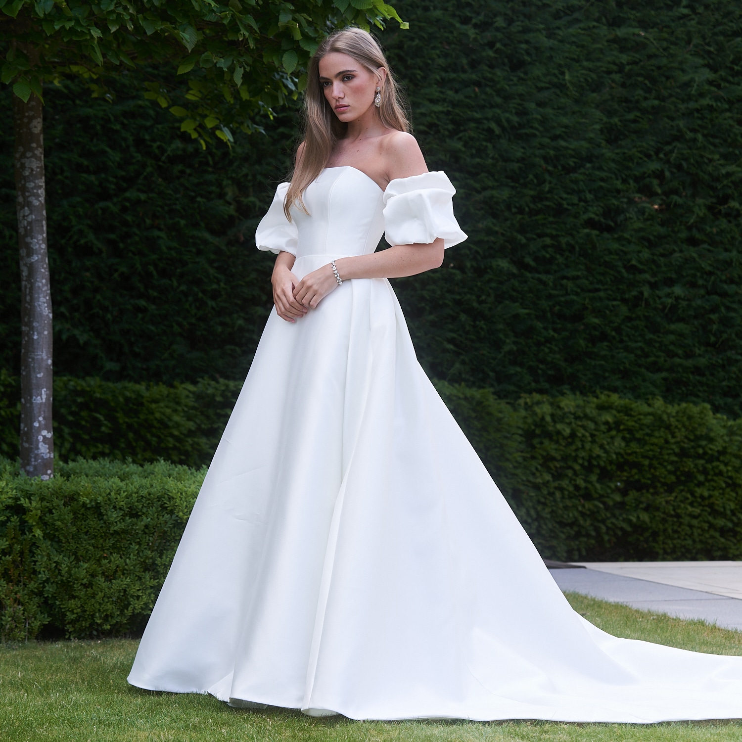 The Caroline Castigliano Tribute wedding gown is a breathtaking embodiment of modern bridal elegance. Handcrafted from luminous lightweight Italian Mikado silk, this masterpiece exudes an air of timeless sophistication. Find your dream wedding dress at Your Dream Bridal near Boston.