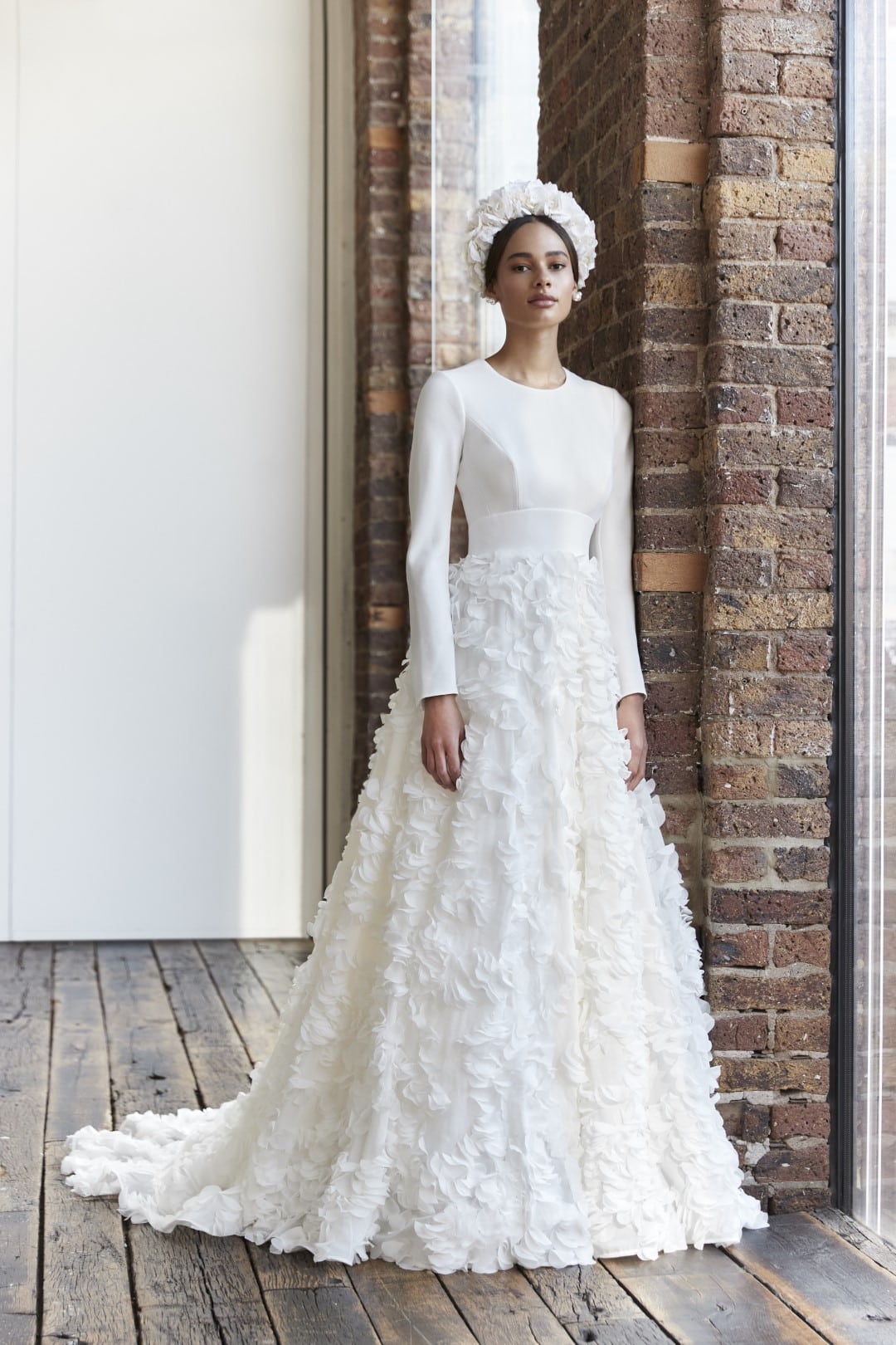 Sassi Holford Tara crowning glory is her feature skirt crafted from 3D chiffon applique that creates volume and drama as you walk down the aisle. Book your bridal appointment at Your Dream Bridal Boston.